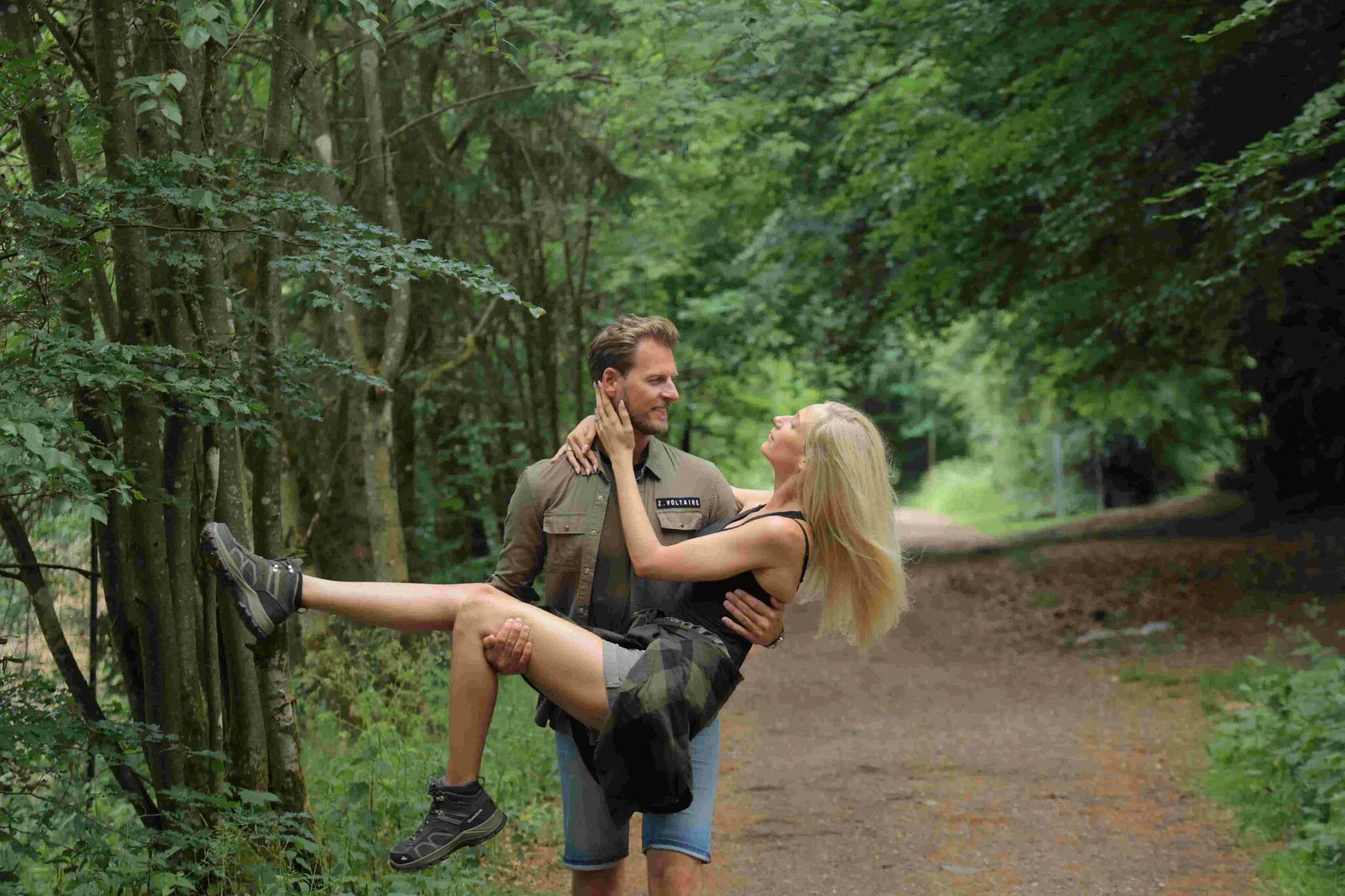 Couple hiking in the High Fens A man carrying his wife on a hike in the Belgian Ardennes